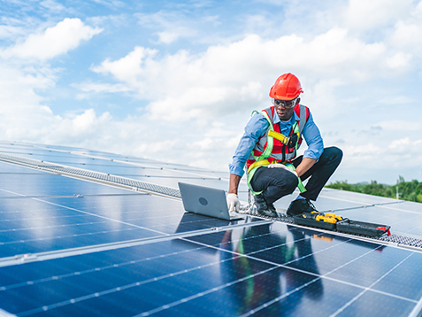 Male professional engineer installing solar photovoltaic panel system, Electrician mounting blue solar module technology on power industrial factory roof, Alternative energy ecological technician job