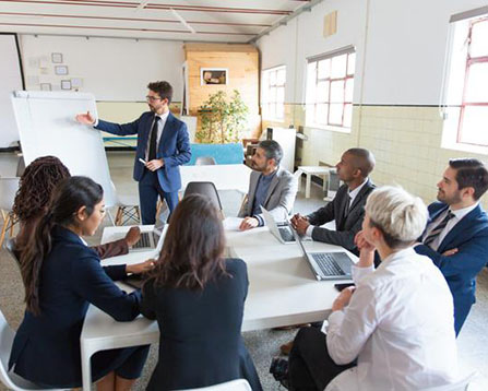 Man presenting to colleagues in meeting