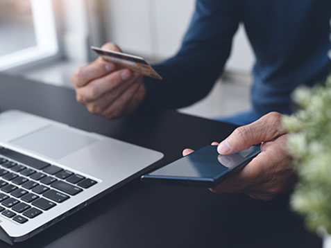 Digital banking, online shopping, internet payment, Ecommerce, financial technology concept. Man online shopping by credit card payment via mobile phone application and laptop computer at home, close up