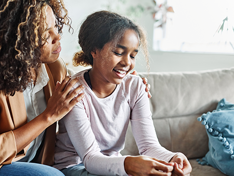 Mother with her teenage daughter at meeting with social worker, psychologist discussing mental health family sitting on sofa in psychotherapist office