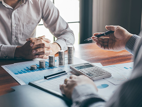 Business group brainstorming on meeting to planning project finance analyzing calculate with report document, stacking coins for step up growing business to profit and saving with wealth management.