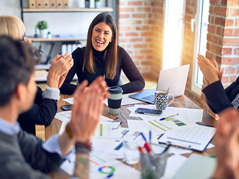 Group of business workers smiling happy and confident. Working together with smile on face applauding one of them at the office