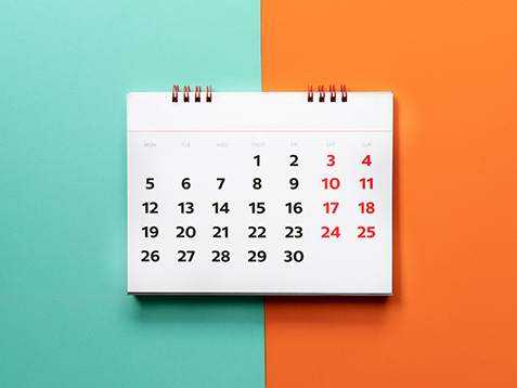 close up of calendar on the color table, planning for business meeting or travel planning concept