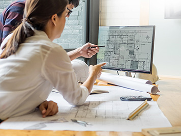 professional architect designer structural engineer team colleagues working office looking computer discussing building plan design project 