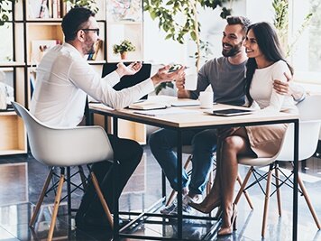 a couple having a meeting with a business man