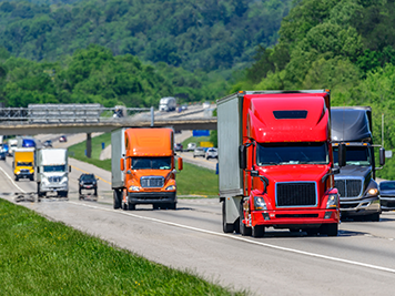 Multiple semitrucks driving on a highway