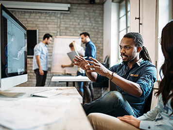 Young architects working on project in office together