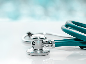 Stethoscope or phonendoscope on a doctor's white desk on cloudy morning, for treatment of cold or flu.