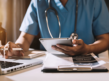 Medical technology concept. Doctor working with mobile phone and stethoscope in modern office