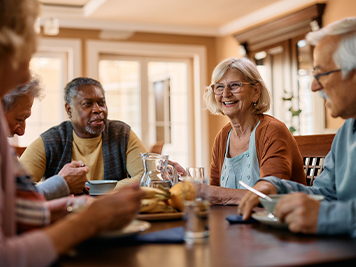 seniors eating together at dinner table