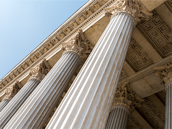 A close up of columns on government building