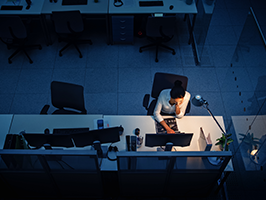 Working Late at Night in the Office: Businesswoman Using Desktop Computer, Analyzing, Using Documents, Solving Problems, Finishing Project. High Angle Shot