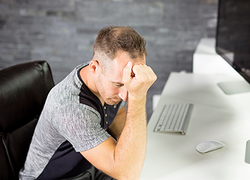 A Young business man with problems and stress in the office